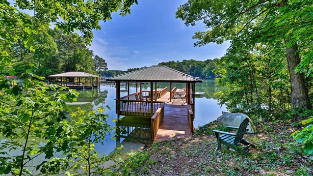 A wooden dock leading to a gazebo with benches, surrounded by trees and a calm lake. - Dock & Pavilion! Lake Norman Retreat on Quiet Cove (Mooresville)