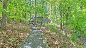 A forested area with a wooden pathway leading to a cabin. - Dock & Pavilion! Lake Norman Retreat on Quiet Cove (Mooresville)