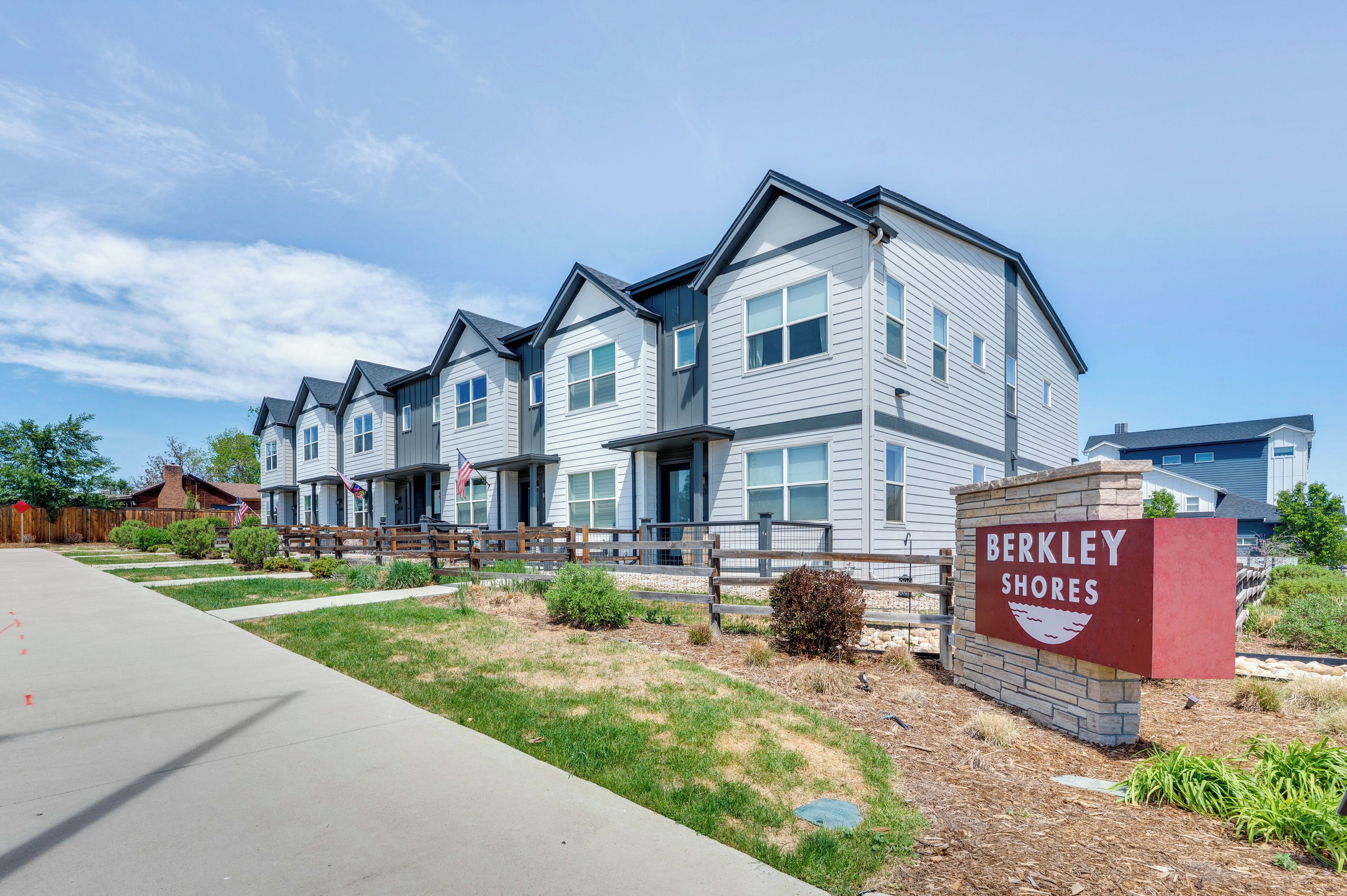 A multi-story residential building with a sign reading 'BERKLEY SHORE.'