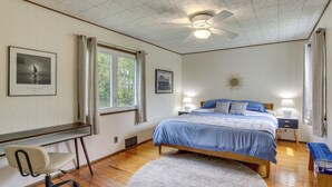 A bedroom with a bed, desk, chair, ceiling fan, and two bedside lamps. - Lakefront Bliss in Mahopac! Charming Home w/ Dock (Mahopac)