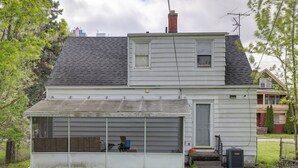 A two-story house with a garage, a chimney, and a small window. - Walk to Falls, Casino! Niagara Family Home w/ Yard (Niagara Falls)