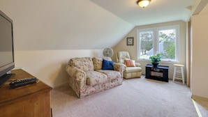 A living room with a sofa, armchair, and a small table with a plant. - Walk to Falls, Casino! Niagara Family Home w/ Yard (Niagara Falls)