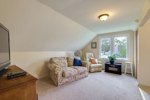 A living room with a sofa, armchair, and a small table with a plant. - Walk to Falls, Casino! Niagara Family Home w/ Yard (Niagara Falls)