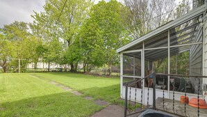 A covered outdoor area with a lawn, a pathway, and a grill. - Walk to Falls, Casino! Niagara Family Home w/ Yard (Niagara Falls)