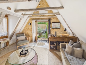 An attic room with a loft bed, a sofa, a small table, and a dining area with a view of the garden. - Authentic family home near village - 6 ppl (Domme)