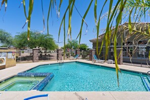 A swimming pool with a hot tub, lounge chairs, and a fenced area with a slide. - Luxury Cave Creek Townhome Near Golf, TPC & Scottsdale (Phoenix)