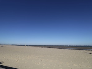 A wide sandy beach with a clear blue sky. - Hamilton's Studio (Ryde)