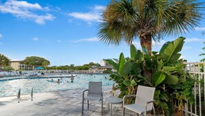 A swimming pool area with lounge chairs and a palm tree. - Ocean View- Diamond Level- Admiral's Row A4-Professionally Managed by HHIB&T Vacation Rentals (Hilton Head Island)