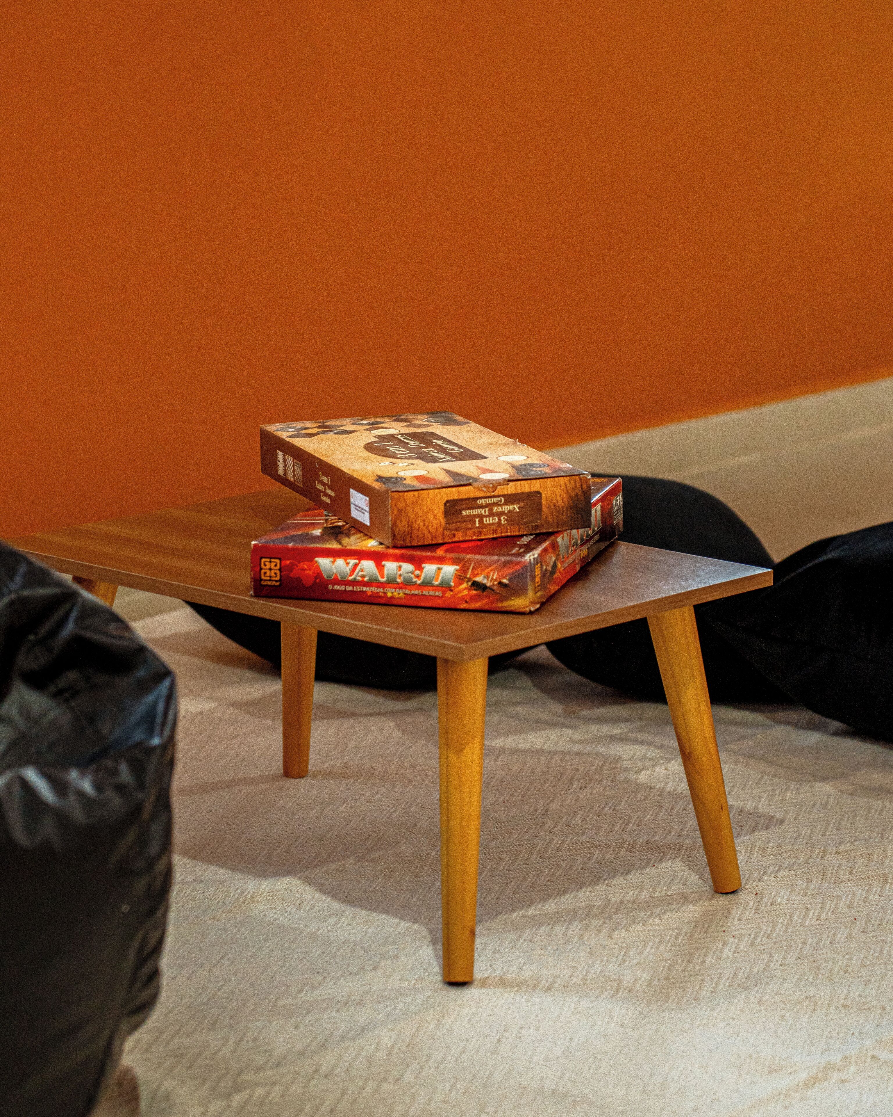 A small wooden table with two board games on top.