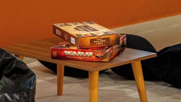 A small wooden table with two board games on top.