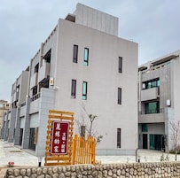 A modern building with a sign indicating a residential area.