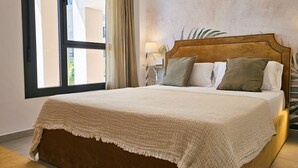 A bed with a headboard, a bedside lamp, and a window with curtains. - ALLONBAY beach front residence (Villajoyosa)