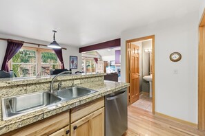 A kitchen with granite countertops, stainless steel sink, and a dishwasher. - Keystone Mtn Retreat w/ Hot Tub and Views! (Keystone)