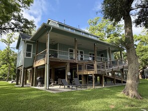 A two-story house with a balcony and a covered porch.