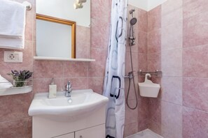 A bathroom with a sink, mirror, shower, and towel rack. - Istrian Villa Stella for 8: Pool & Sauna (Labin)
