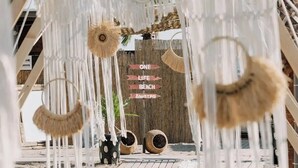 A beach-themed entrance with hanging decorations and a sign reading 'ONE LIFE BEACH.' - one lıfe stone (Ayvalık)