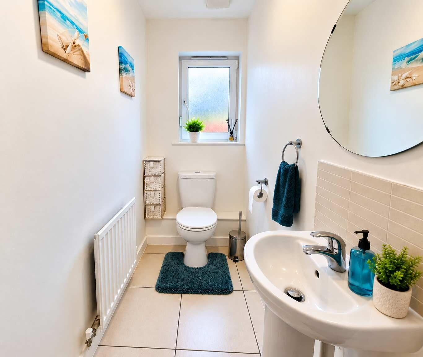 A bathroom with a toilet, sink, and a window.