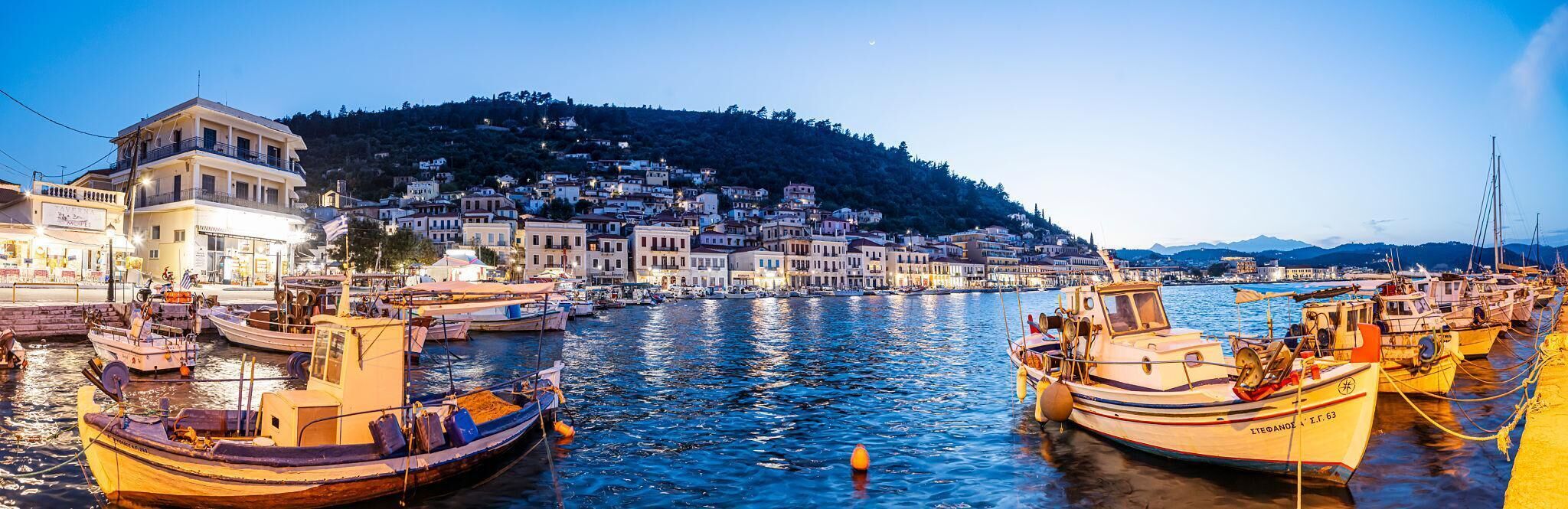 Experience the vibrant Gytheio harbor atmosphere by night