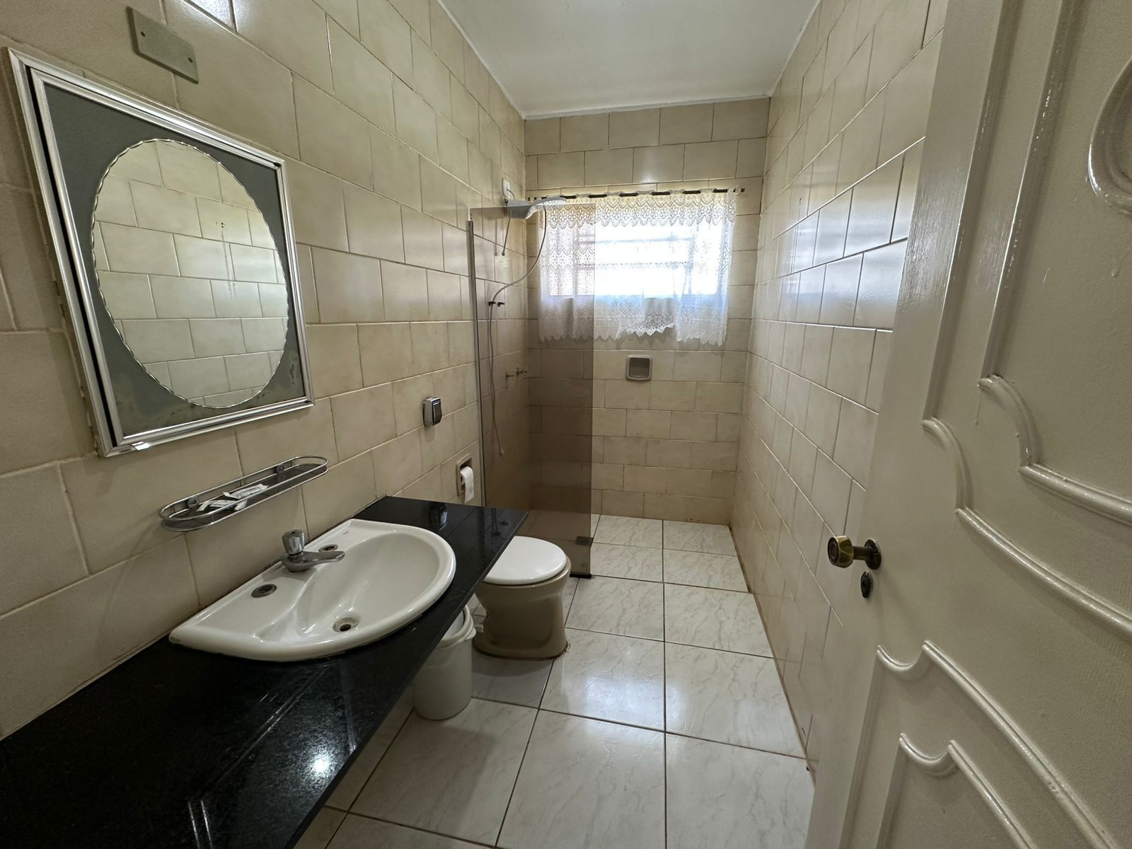 A bathroom with a sink, toilet, and shower.