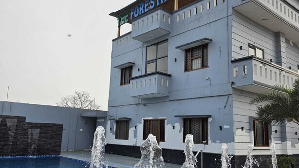 A building labeled 'FORESTA RESORT' with a pool and multiple water fountains. - THE FORESTAA RESORT (Haridwar)