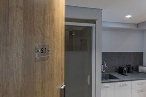 Una cocina moderna con horno integrado, un lavabo y una cafetera.