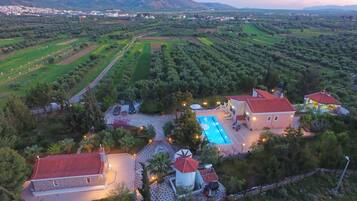 A large property with multiple buildings, a swimming pool, and a well-maintained garden.