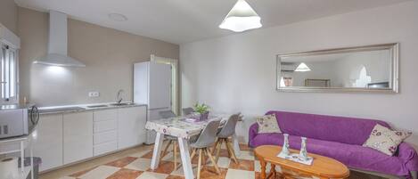 A compact living space with a kitchen, dining area, and seating area.