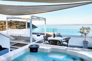 A rooftop terrace with a hot tub, seating area, and a view of the sea. - Seafront Villa Moments, by Estia (Mochlos)
