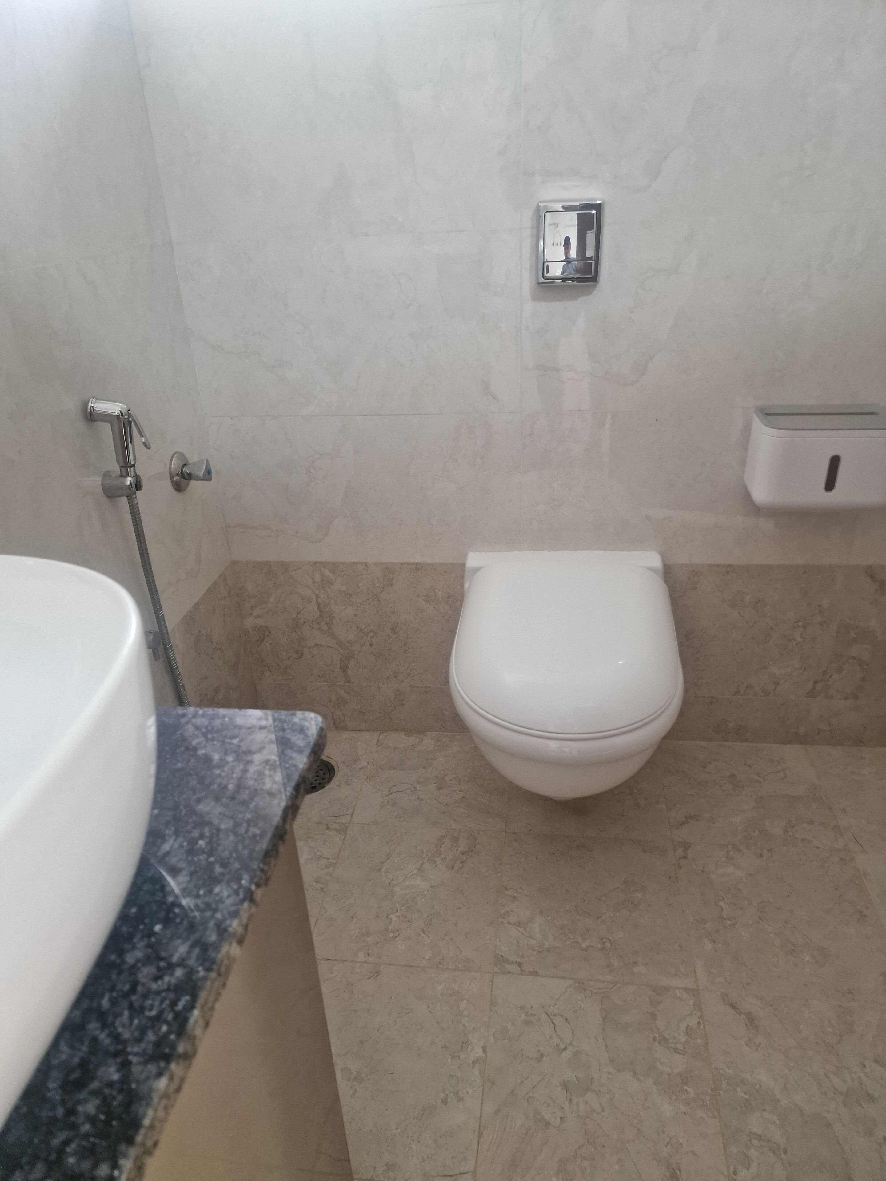 A bathroom with a toilet, a sink, and a shower.