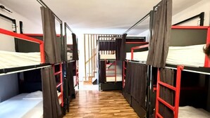 A corridor with bunk beds on either side, wooden flooring, and a staircase in the center. - Majka Guest House (Kotor)