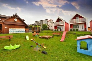A playground with swings, slides, and a seesaw.