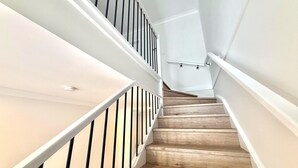 A staircase with wooden steps and white railings.