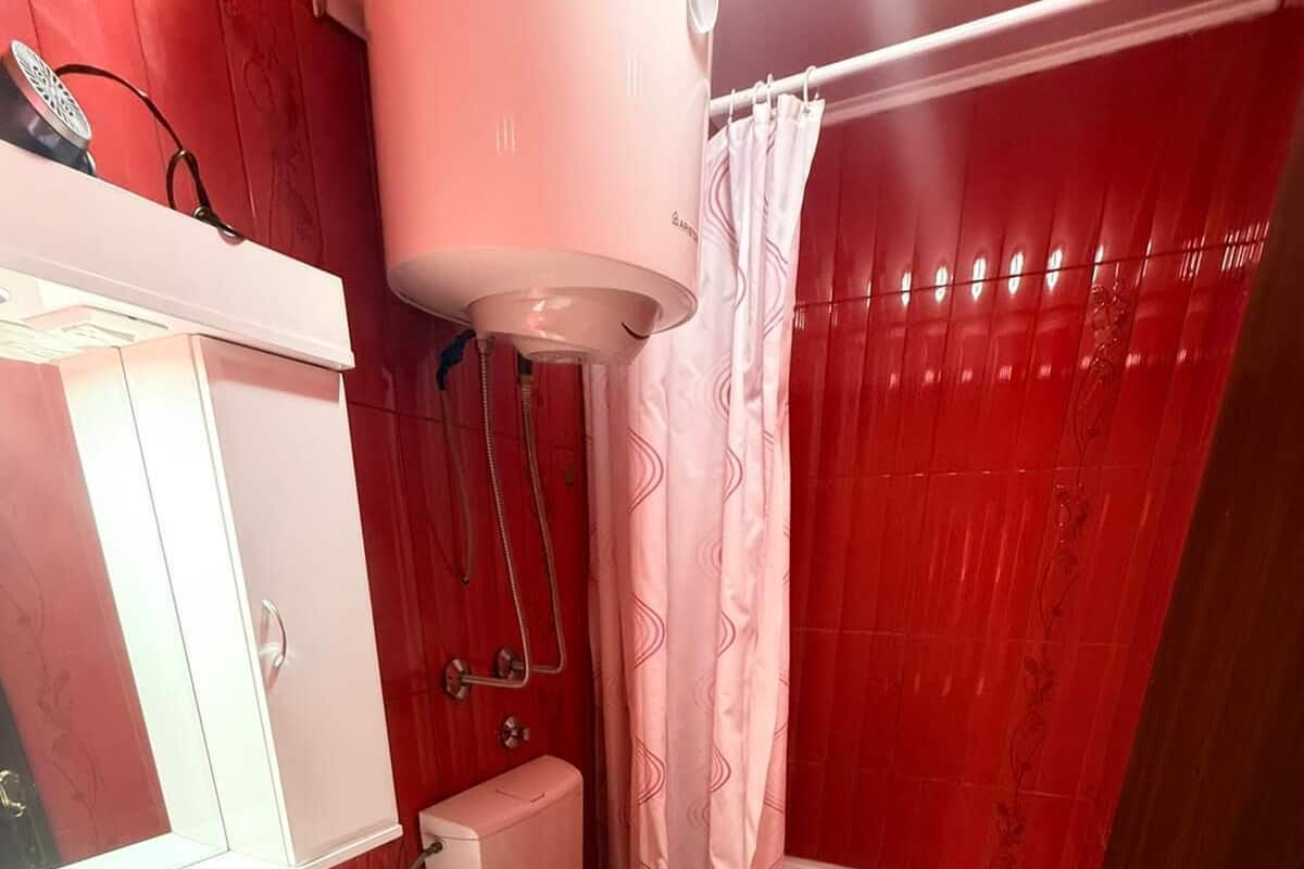 A bathroom with a toilet, sink, shower, and bathtub.