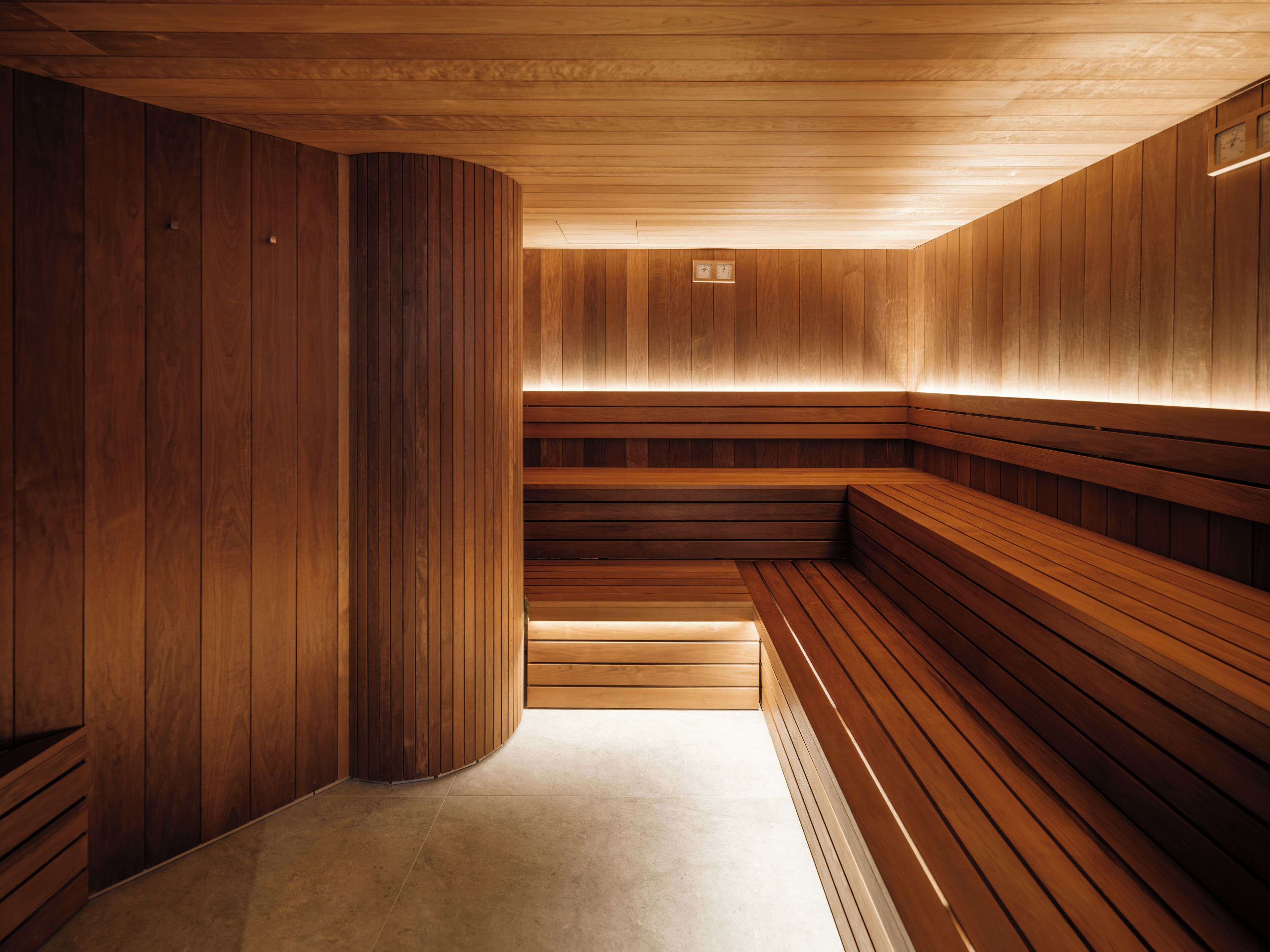 A sauna with wooden benches and a tiled floor.