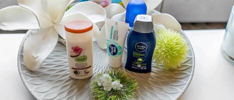 A tray with various personal care products, including a bottle of Nivea Men Fresh Energy, a jar of aloe vera gel, and a container of body lotion.