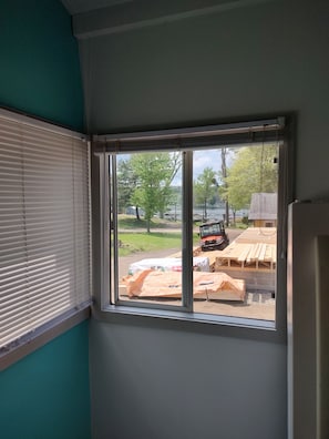 A room with a window overlooking a construction site.