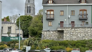 A building with a stone facade, multiple windows, and a balcony. - Apartment 514 - Clifden - sleeps 6 guests  in 3 bedrooms (Clifden)