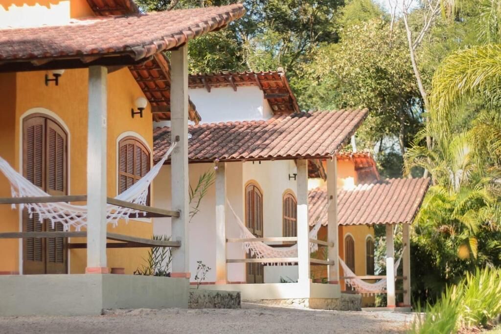 A traditional building with multiple rooms, each with a tiled roof and wooden shutters.