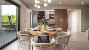 A modern dining area with a round table, six chairs, a chandelier, and a view of the outdoors. - La Residenza Vila apartment I for 6 guest's 1,5 km from sea (Poreč)