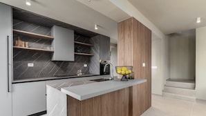 A modern kitchen with a marble backsplash, wooden cabinetry, and a built-in island. - La Residenza Vila apartment I for 6 guest's 1,5 km from sea (Poreč)