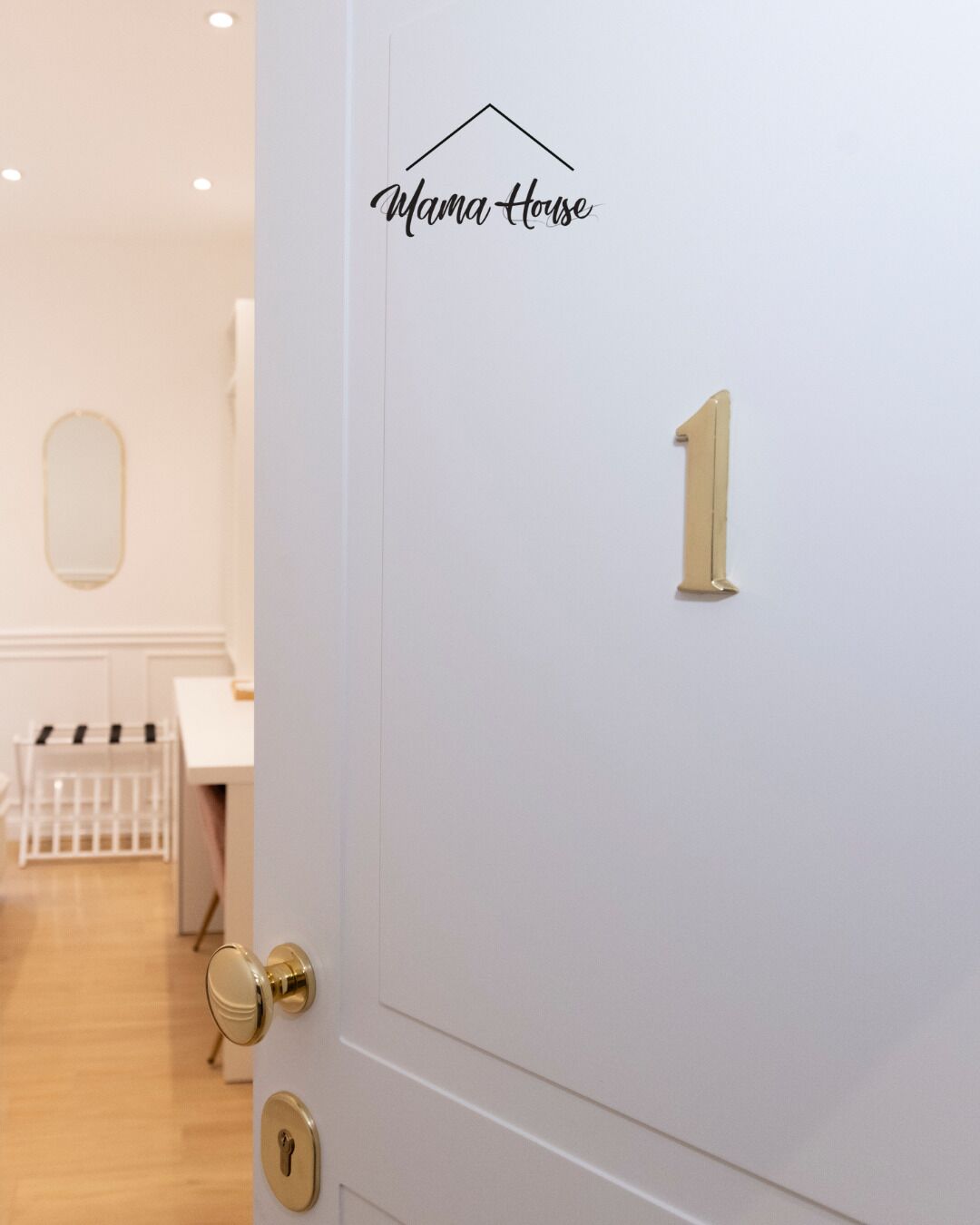A white door with the number 1, a gold door handle, and a keyhole.