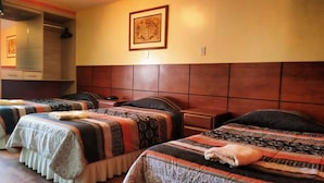 A hotel room with two beds, a wardrobe, a mirror, and a framed picture on the wall. - hotel mamatila (Lima)