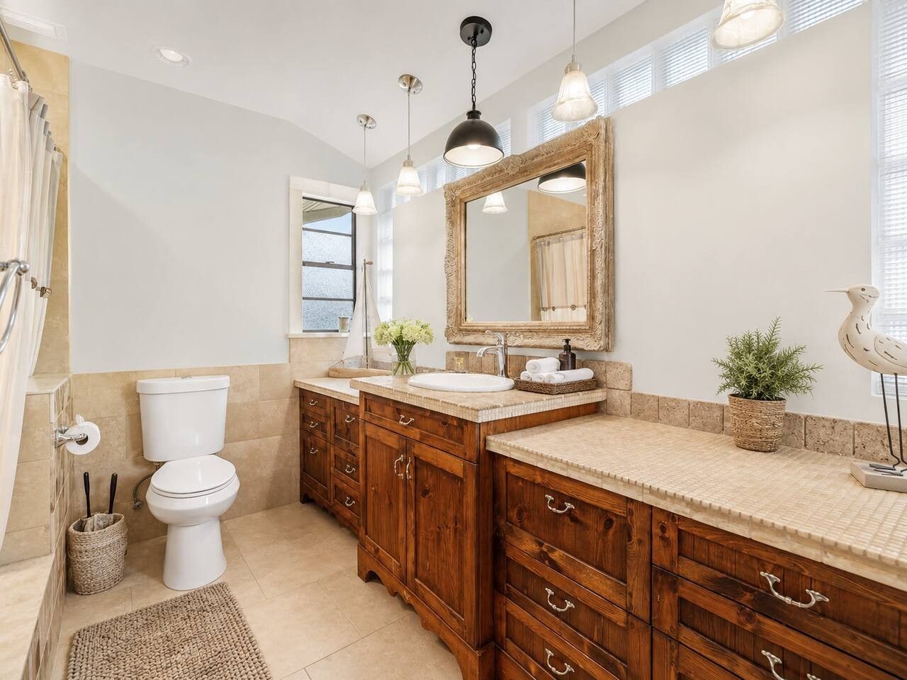 Stylish Bathroom: Elegant wood cabinetry and natural light await for your refreshing retreats!