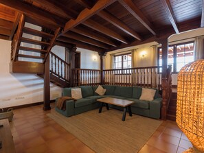 A living room with a wooden staircase, a green sofa, a small table, and a patterned lamp. - Villa with private swimming pool in Puerto Calero, Lanzarote (Puerto Calero)