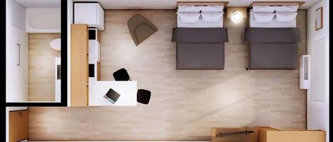 A hotel room with two beds, a desk, a chair, a wardrobe, and a mirror.