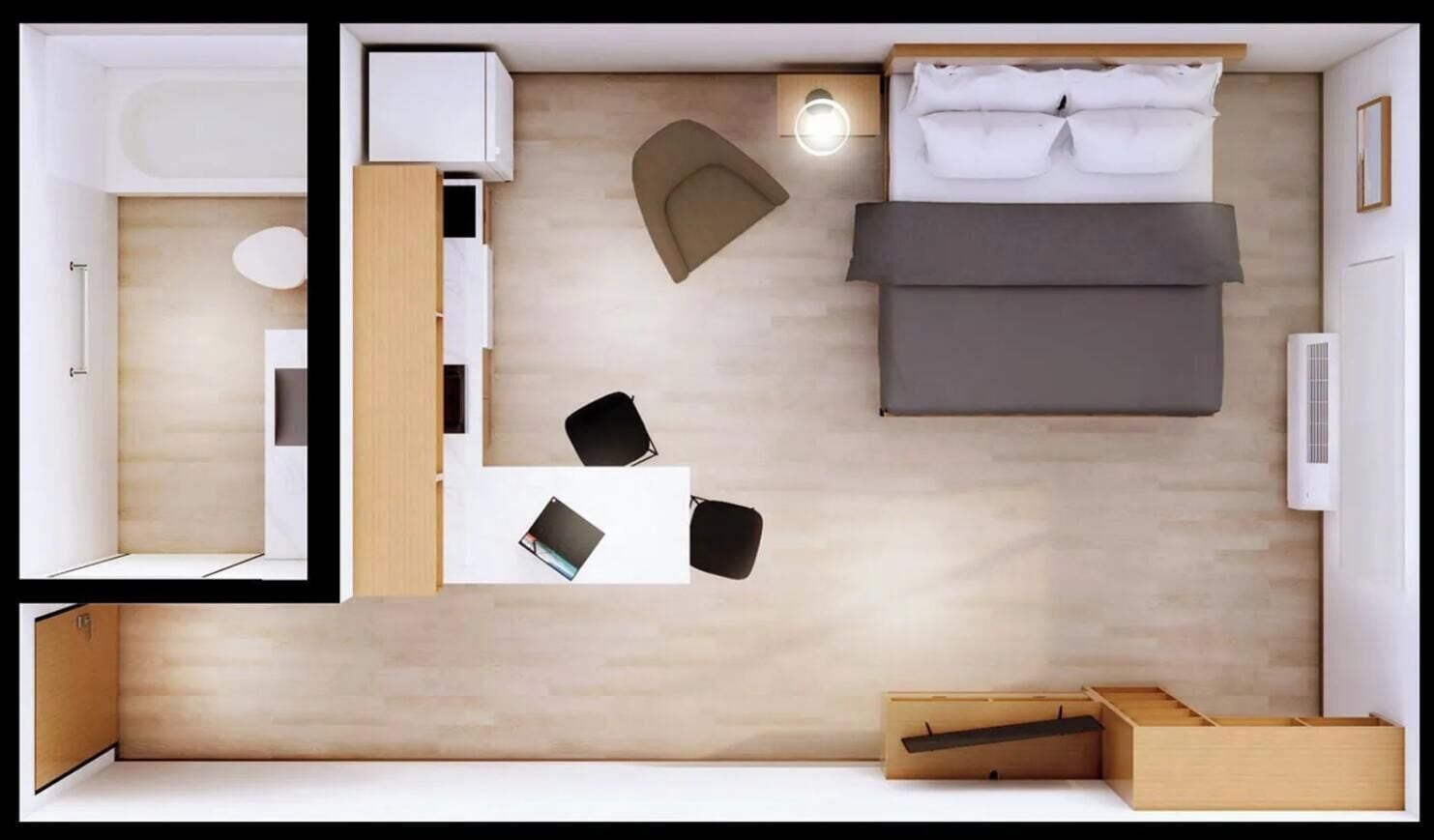 A compact room with a bed, a small table, a chair, a desk, and a built-in wardrobe.