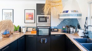 A modern kitchen with a built-in oven, microwave, and sink.