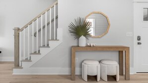 A staircase with wooden handrails and a white wall. - The Getaway, just blocks from the ocean. (Carolina Beach)