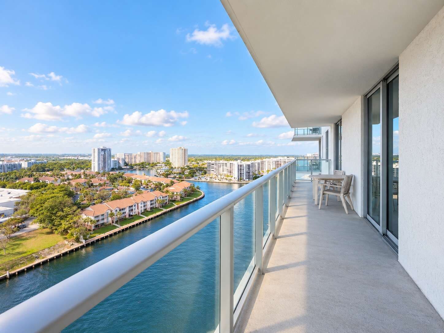 A balcony with a view of a river and buildings.