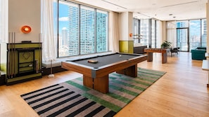 A modern living room with a pool table, a sofa, and a dining area. - Stylish 1BR in the Heart of Miami (Miami)